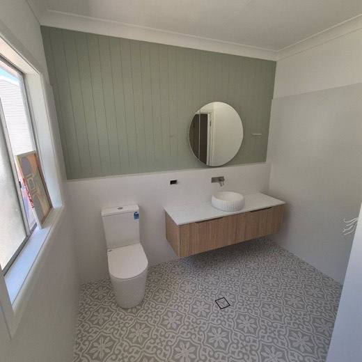 A finished bathroom vanity and floor tiled by Cruz Conroy Tiling and Stone