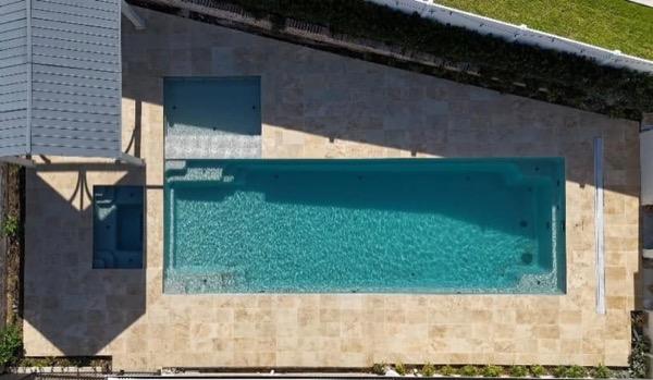 A pool with a stone surround seen close to the water line